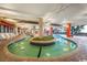 Bright indoor lazy river featuring lounge chairs and views of palm trees and the beach at 7200 N Ocean Blvd. # 222, Myrtle Beach, SC 29572