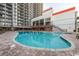 Large outdoor pool surrounded by plenty of lounge chairs and tables at 7200 N Ocean Blvd. # 222, Myrtle Beach, SC 29572