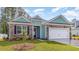 Inviting exterior featuring stone accents, turquoise siding, and a well-manicured lawn at 725 Doonbeg Ct., Conway, SC 29526