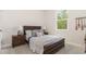 A bright bedroom with a large window and wooden bed frame with bedside tables at 729 Doonbeg Ct., Conway, SC 29526