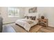 A cozy bedroom with a large window, comfortable bed, and soft neutral tones at 729 Doonbeg Ct., Conway, SC 29526