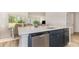 Modern kitchen with large quartz countertop island and stainless steel dishwasher with bright, open concept at 729 Doonbeg Ct., Conway, SC 29526