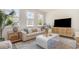 Bright living room with white sofa, modern decor, and large windows for natural light viewing outside at 729 Doonbeg Ct., Conway, SC 29526
