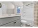 The bathroom showcases modern grey vanity and a shower/tub combination with white tile at 733 Doonbeg Ct., Conway, SC 29526