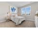 Cozy bedroom featuring a bed with blue accents and bedside tables with lamps, bathed in natural light at 733 Doonbeg Ct., Conway, SC 29526