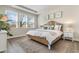 Serene bedroom with a woven headboard, white bedding, and large windows for ample natural light at 733 Doonbeg Ct., Conway, SC 29526