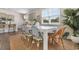 An expansive dining room features a large white table, stylish seating, and plenty of natural light at 733 Doonbeg Ct., Conway, SC 29526