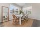 Bright dining room featuring a white table, stylish chairs, and a large window for natural light at 733 Doonbeg Ct., Conway, SC 29526