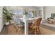 Well-lit dining area with a white table, stylish chairs, and views into the living room at 733 Doonbeg Ct., Conway, SC 29526