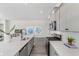 Open kitchen features quartz countertops, stainless appliances, and bar seating at 733 Doonbeg Ct., Conway, SC 29526