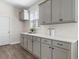 Bright kitchen with gray cabinets, a window, and ample counter space at 733 Doonbeg Ct., Conway, SC 29526