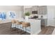 Stylish kitchen boasts gray cabinets, quartz countertops, and stainless steel appliances at 733 Doonbeg Ct., Conway, SC 29526