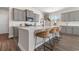 Bright kitchen features a large island with bar seating and gray cabinets at 733 Doonbeg Ct., Conway, SC 29526