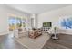 Bright living room featuring a comfortable sofa, stylish decor, and a large sliding glass door at 733 Doonbeg Ct., Conway, SC 29526