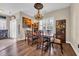 Elegant dining room with chandelier, decorative art, shutters, and wood floors at 773 Wintercreeper Dr., Longs, SC 29568