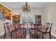 Beautiful dining room features chandelier, artwork, shutters, and wood flooring at 773 Wintercreeper Dr., Longs, SC 29568