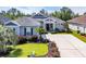 Beautiful single-story home with well-manicured lawn and garden beds, plus an ample driveway and welcoming entryway at 773 Wintercreeper Dr., Longs, SC 29568