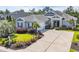 Attractive single-story home featuring a two-car garage, mature landscaping, and a concrete driveway at 773 Wintercreeper Dr., Longs, SC 29568