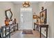 Elegant home foyer featuring a decorative antler chandelier, accent furniture, and tile flooring at 773 Wintercreeper Dr., Longs, SC 29568