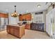 Spacious kitchen features an island, stainless steel appliances, and warm wood cabinetry at 773 Wintercreeper Dr., Longs, SC 29568