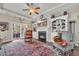 Cozy living room featuring a fireplace, built-in shelving, backyard access, and hardwood floors at 773 Wintercreeper Dr., Longs, SC 29568