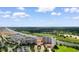An aerial showcases lush greenery surrounding a waterway, nearby marina, golf course, and residences at 8121 Amalfi Pl. # 4-1006, Myrtle Beach, SC 29572