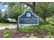 Marina Inn at Grande Dunes sign surrounded by lush greenery on a sunny day at 8121 Amalfi Pl. # 4-1006, Myrtle Beach, SC 29572