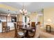 Dining area with wood table, chairs, and chandelier, adjacent to kitchen and bedroom at 8121 Amalfi Pl. # 4-1006, Myrtle Beach, SC 29572