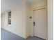 Exterior shot of a unit showing the entrance door with view along a walkway at 8121 Amalfi Pl. # 4-1006, Myrtle Beach, SC 29572