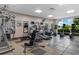 Well-equipped fitness center featuring modern cardio machines and weight-training equipment with views of the community grounds at 8121 Amalfi Pl. # 4-1006, Myrtle Beach, SC 29572