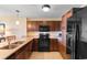 Bright kitchen with stainless steel appliances and granite countertops with wooden cabinetry at 8121 Amalfi Pl. # 4-1006, Myrtle Beach, SC 29572
