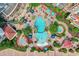 Aerial shot of the community pool, lounge chairs, umbrellas, and tropical landscaping at 8121 Amalfi Pl. # 4-1006, Myrtle Beach, SC 29572
