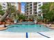 Relaxing outdoor pool area with lush landscaping at 8121 Amalfi Pl. # 4-1006, Myrtle Beach, SC 29572