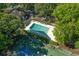 Community pool and tennis court surrounded by trees at 830 44Th Ave. N # T3, Myrtle Beach, SC 29577