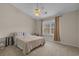 Bedroom with neutral walls, ceiling fan, and a window letting in natural light, creating a peaceful retreat at 830 44Th Ave. N # T3, Myrtle Beach, SC 29577
