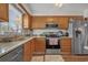 Well-lit kitchen with stainless steel appliances, light wood cabinets, and granite countertops at 830 44Th Ave. N # T3, Myrtle Beach, SC 29577