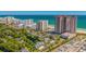 Aerial view capturing oceanfront condos surrounded by lush trees, a pond, and nearby amenities at 8500 Margate Circle # 505, Myrtle Beach, SC 29572