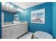 Modern bathroom with blue walls, seagull artwork, and bright vanity at 8500 Margate Circle # 505, Myrtle Beach, SC 29572