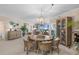 Open-concept dining area with stylish light fixture, coastal decor, and views of the living area and ocean at 8500 Margate Circle # 505, Myrtle Beach, SC 29572