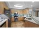 Bright kitchen with stainless steel appliances, stone countertops, tiled backsplash and breakfast bar with views into other rooms at 8500 Margate Circle # 505, Myrtle Beach, SC 29572