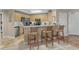 Cozy kitchen features stainless steel appliances, tiled backsplash, breakfast bar with stool seating and views of the living area at 8500 Margate Circle # 505, Myrtle Beach, SC 29572