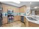 Well-lit kitchen features stainless steel appliances, tile backsplash, ample counter space, and modern finishes at 8500 Margate Circle # 505, Myrtle Beach, SC 29572