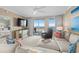 Inviting living room featuring a large sectional couch and ocean view balcony at 8500 Margate Circle # 505, Myrtle Beach, SC 29572