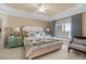 Bright main bedroom with tray ceiling, sitting area, and decorated in cool tones at 8500 Margate Circle # 505, Myrtle Beach, SC 29572