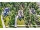 Aerial view of a stately home with a large yard, mature trees, long driveway, and well-maintained landscaping at 904 Moultrie Circle, Myrtle Beach, SC 29588