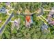 Aerial view of a home in a wooded neighborhood featuring mature trees, well-manicured lawns, and nearby streets at 904 Moultrie Circle, Myrtle Beach, SC 29588