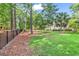 Expansive backyard with lush greenery, mature trees, and privacy fence at 904 Moultrie Circle, Myrtle Beach, SC 29588
