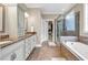 Beautiful bathroom boasts double vanities, a soaking tub, and a separate glass-enclosed shower at 904 Moultrie Circle, Myrtle Beach, SC 29588