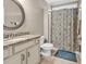 Bathroom featuring granite countertops, a shower with patterned curtains, and ceramic floors at 904 Moultrie Circle, Myrtle Beach, SC 29588