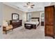 Well-lit bedroom featuring a tray ceiling, ceiling fan, and furniture at 904 Moultrie Circle, Myrtle Beach, SC 29588